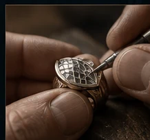 Hands refining a metal ring at the bench